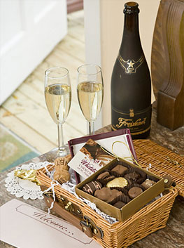 a basket of sweet treats with champagne
